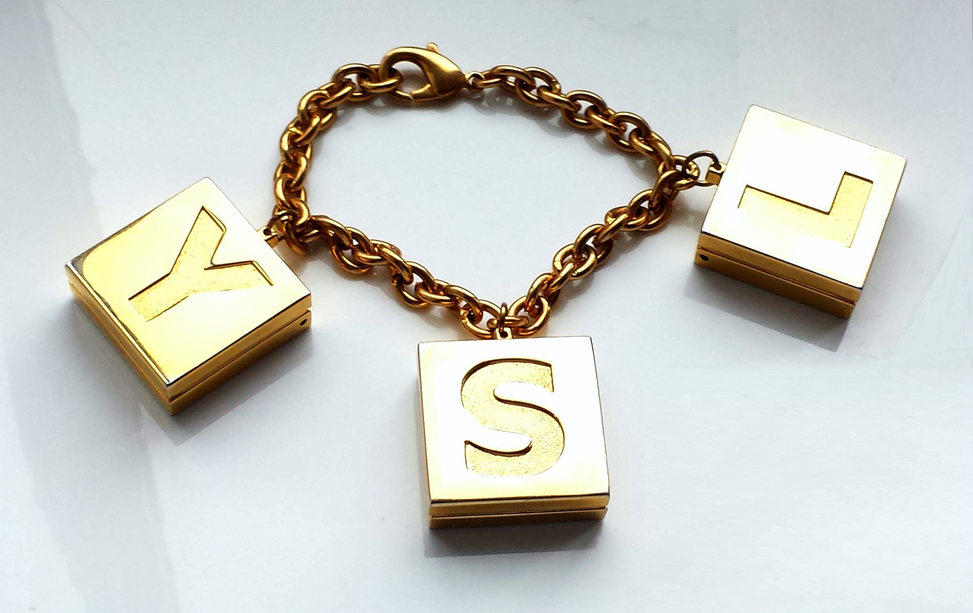 Vintage YSL Yves Saint Laurent Gold Tone Limited Edition Bracelet with Lip Gloss