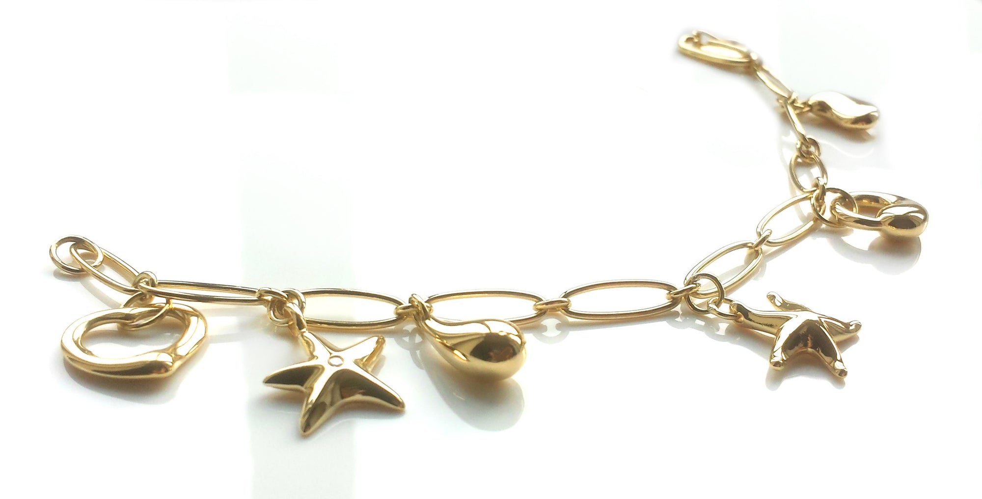Tiffany & Co. Charm Bracelet by Elsa Peretti in 18k Gold – with Extra Charm