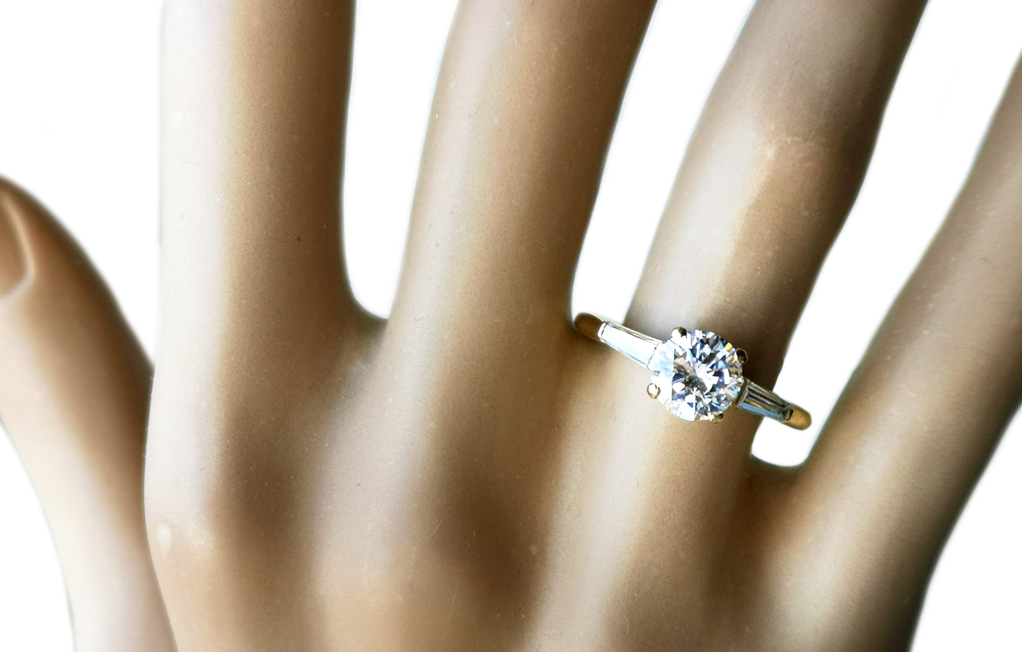 Cartier 1.01ct D/VVS2 Round Brilliant & Tapered Baguette Diamond Engagement Ring in 18K Gold on finger
